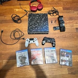 PS4 Slim 1 TB 2 controllers 4 games and all of the power cords